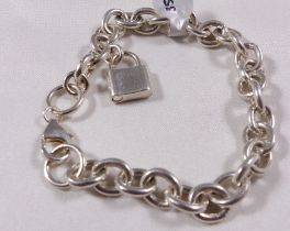 SILVER CHARM BRACELET. Sterling silver solid charm bracelet with modern padlock