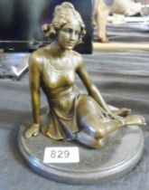 BRONZE LADY. Bronze lady seated on a marble base