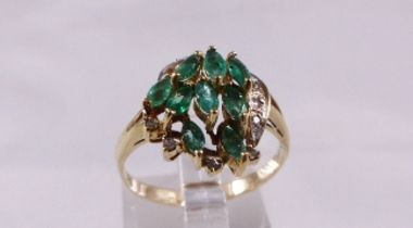 9CT DIAMOND RING 9ct gold ring set with nine marquise cut emeralds and diamonds