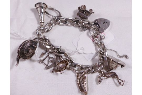 SILVER CHARM BRACELET. 925 silver charm bracelet with padlock clasp and ten 925 silver charms, 51.