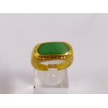 24CT RING WITH JADE INSERT. 24ct gold ring with jade insert, size O/P, 8,3g