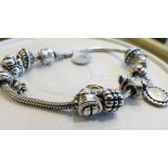 PANDORA CHARM BRACELET. Genuine Pandora sterling silver charm bracelet with nine Pandora charms, one