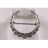 18CT AND DIAMOND BROOCH. 18ct white gold and diamond cresent brooch