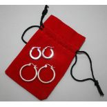 EARRINGS - a pair of 9ct white gold hooped earrings at 2.2g and a pair of silver hooped earrings.