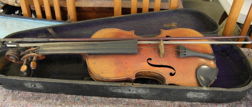 VIOLIN - a cased copy of a Joseph Guarnerius violin with a bow featuring mother of pearl inlay.