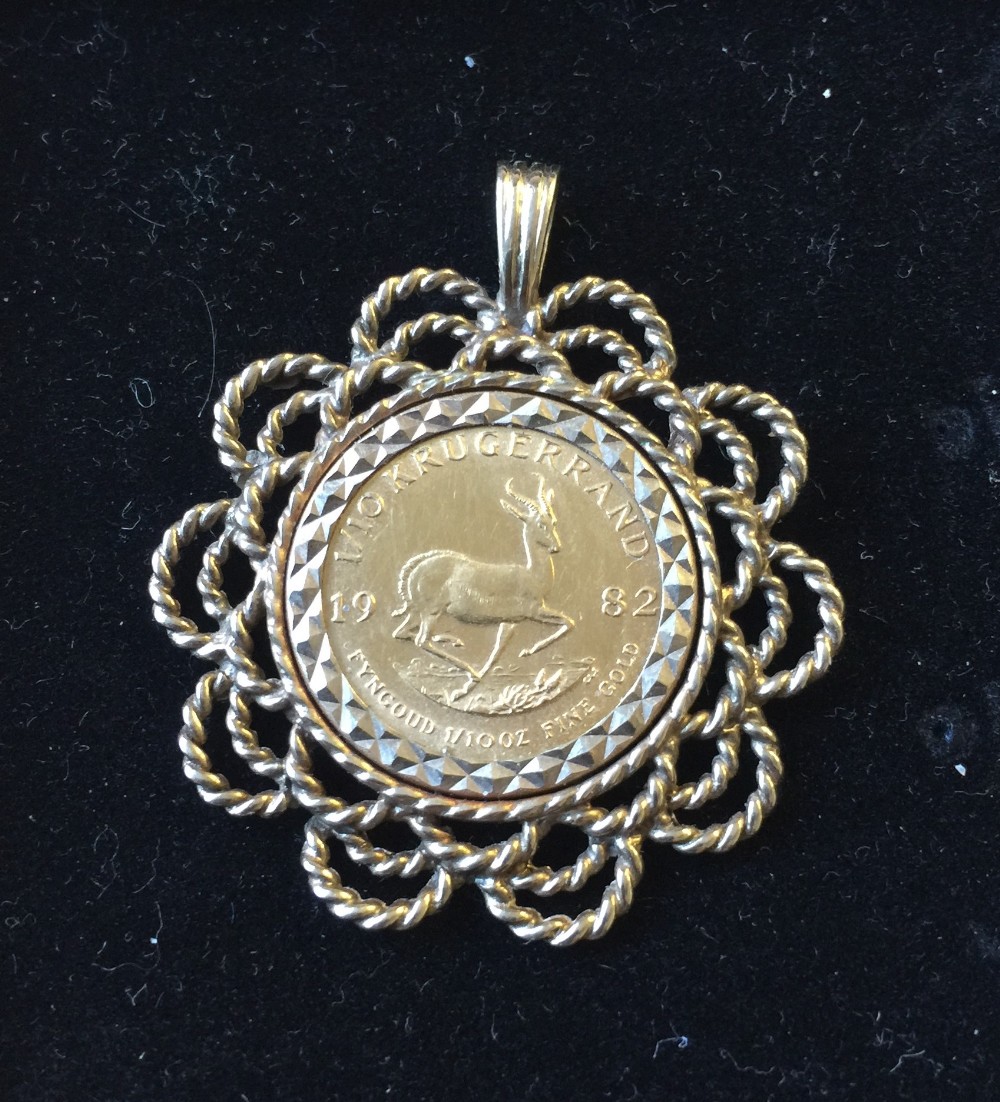 KRUGERRAND - a 1/10th 1982 Krugerrand coin mounted in a 9ct gold pendant. Total weight 7.