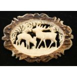 DEER BROOCH - a vintage carved bone brooch depicting a stag and fawn within leafy foliage.