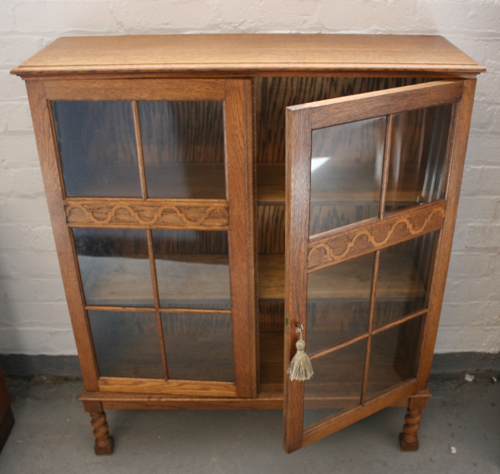 BOOKCASE - a vintage lockable glass doored bookcase with patterned detail on the door.