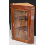 CORNER CABINET - a mahogany wall mounted corner cabinet featuring two shelves behind a glass door.