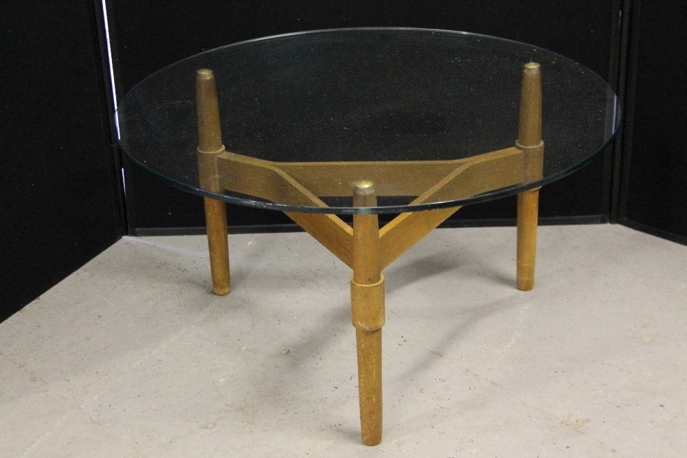 GLASS COFFEE TABLE - a round glass coffee table with wooden three legged base, measuring 30"dx16"h.