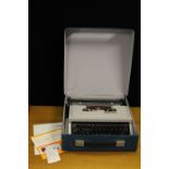 TYPEWRITER - an Olivetti 'Dora' typewriter in original record case style carry case with original