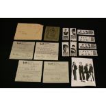 THE BEATLES - a photograph featuring the four Beatles with secretarial autographs on the reverse.