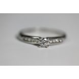 DIAMOND SOLITAIRE RING - very pretty example with pave set diamonds to shoulder.