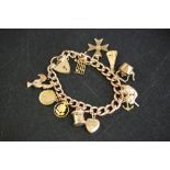 9CT GOLD CHARM BRACELET - a 9ct gold charm bracelet with a number of sweet charms including a