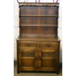 DRESSER - attractive oak dresser with decorative carving, measuring 174x106.5x48cm.