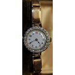 18CT LADIES WATCH - an 18ct gold seventeen jewel Swiss ladies watch on a 9ct gold bracelet,