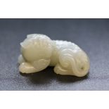 WHITE JADE - a Chinese white jade recumbent lion,