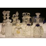 DECANTERS - 12 glass decanters, all with their stoppers and a glass ice bucket.