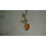 Modern silver and amber pendant on silver necklace