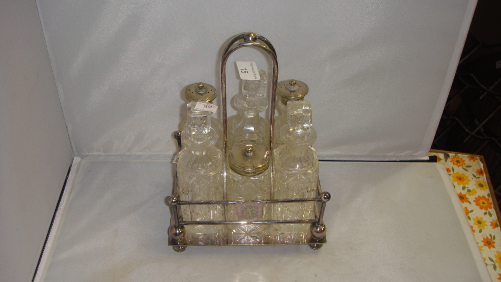 Silver plated cut glass cruet set in silver plated stand