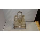 Silver plated cut glass cruet set in silver plated stand