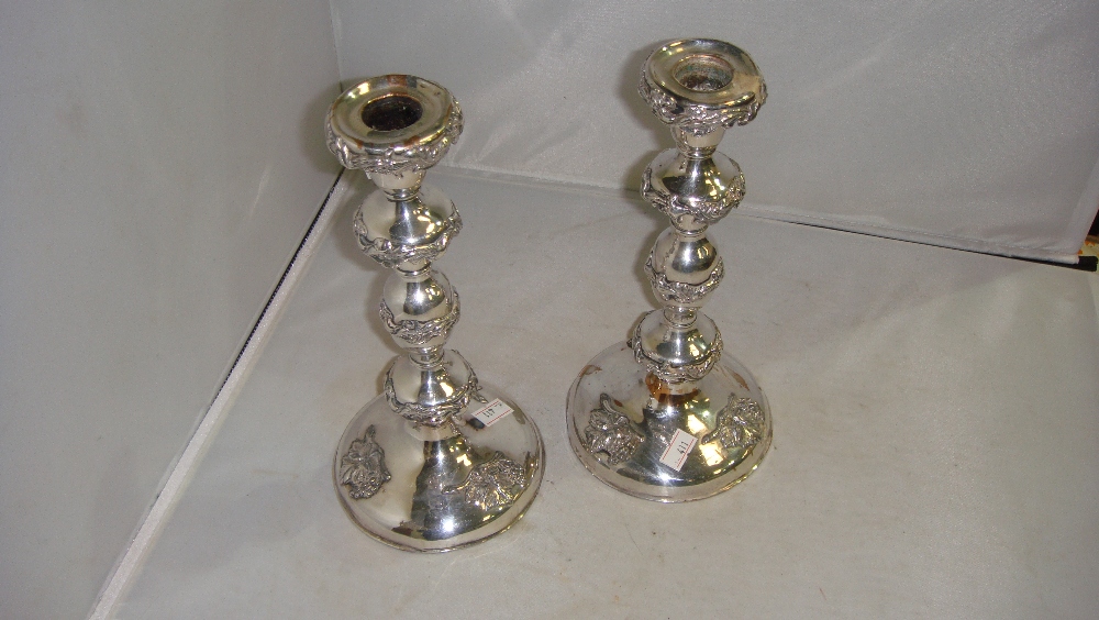 Pair of 19th century Sheffield plate candlesticks decorated with leaf and grape pattern