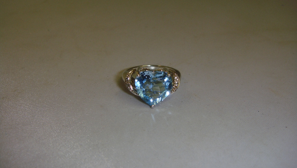 Modern silver and heart shaped blue stone ring 53.