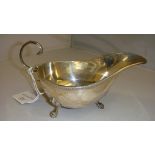 Solid silver sauce boat with tongue and dart decoration on claw feet,