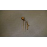 15 ct gold tie pin set with single ruby & unmarked 9 ct gold pin set with cushion cut rose coloured