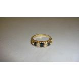 18 ct gold ring set with three dark saphirres and four small diamonds ( 53 m)