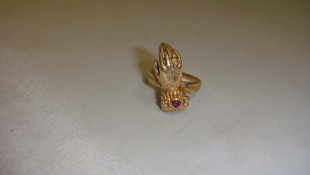 9 ct gold ring modelled as a hand set with hardstones 51.