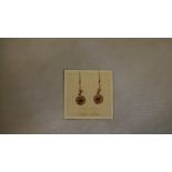 Pair of vintage 9 ct gold earrings worked as a flower and set with a single garnet