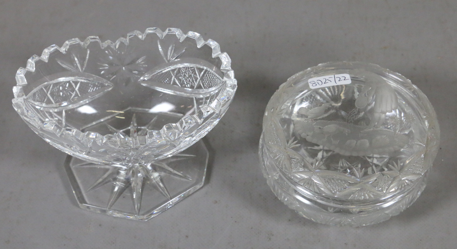 A cut glass powder bowl decorated with a rural scene to the cover along with a cut glass pedestal