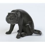 A Japanese Meiji period patinated bronze figure of a seated wild cat decorated with textured fur, 7.