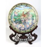 A large Chinese Republic period cloisonne charger on pierced hardwood stand.