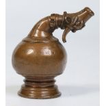A 19th century small Indian copper funnel. With onion shaped bowl terminating with an ox mask, 8.