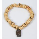 A tribal carved ivory necklace.