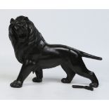 A Japanese patinated bronze model of a lion. Stood on all fours and in mid roar.