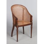 A Victorian carved mahogany and bergere childs tub chair raised on turned supports.