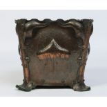 An Arts & Crafts hammered copper jardiniere of square form.