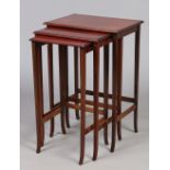 A Victorian mahogany nest of three tables, crossbanded and raised on square tapering supports.
