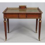 A Victorian mahogany ladies leather top writing desk in the French style with ormolu gallery and