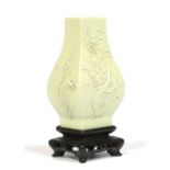 An early 19th century Chinese small archaic square baluster bud vase on carved hardwood plinth.