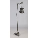 A Japanese bronzed standard lamp formed as a dragon supporting a lantern, 163cm.