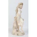 A late 19th century carved white marble statue of a dancing gypsy girl raised on a canted plinth,