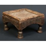 A 19th century African Tribal carved hardwood small square stool, raised on turned bell shaped feet,