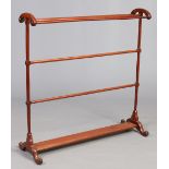 A large Victorian mahogany towel rail raised on scroll supports, 100cm wide.