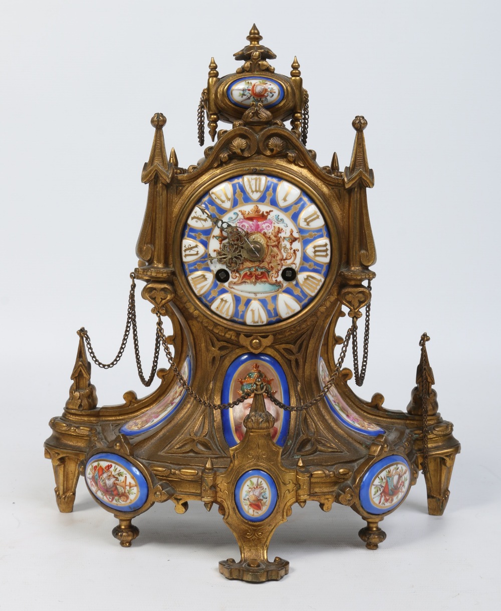 A 19th century Gothic Revival French bronze eight day mantel clock. Set with Sevres style panels.