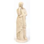 A 19th century small carved white marble statue of a Grecian maiden dressed in flowing robes and