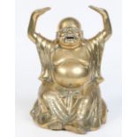 A Chinese polished bronze figure of a Buddha seated with his arms raised and decorated with